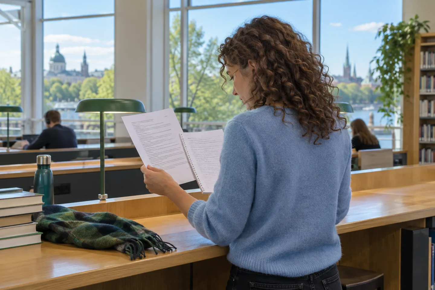 European woman comparing a printed script with a notebook in a bright reading room